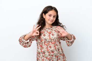 Wall Mural - Little caucasian girl isolated on white background showing ok sign with two hands