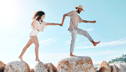 Poster - Beach, rocks and couple with vacation. walking and travel with happiness, bonding together and carefree. Seaside, fun and man with woman, adventure and journey with weekend break and summer holiday