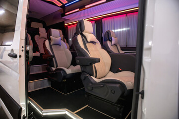 Comfortable interior of a passenger bus with soft seats. The design is made to order. Private covering of cars. Various elements of the bus interior.