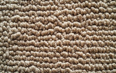 Poster - Close-up of a natural, textured woven jute rug with intricate details and patterns, showcasing the rustic beauty and tactile appeal of organic materials.