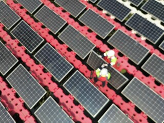 Male workers repair Floating solar panels on water lake. Engineers construct on site Floating solar panels at sun light. clean energy for future living. Industrial Renewable energy of green power.