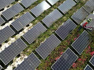 Male workers repair Floating solar panels on water lake. Engineers construct on site Floating solar panels at sun light. clean energy for future living. Industrial Renewable energy of green power.