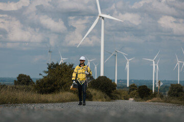 Fototapete - Man engineers holding tools box and rope to maintenance working in wind turbine. Renewable energy power wind turbine. Technology protect environment reduce global warming problems.