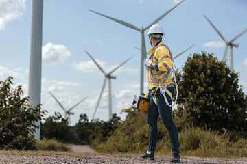 Fototapete - Man engineers holding tools box and rope to maintenance working in wind turbine. Renewable energy power wind turbine. Technology protect environment reduce global warming problems.