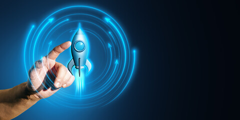 Wall Mural - Hand pointing at a glowing rocket symbol on a digital blue neon background.