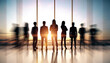 © Who is Danny - Group of business professionals standing confidently in office with blurred motion effect and sunlight through large windows.