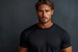 © julija - dynamic fashion photography of a muscular model wearing a black tshirt dramatic lighting emphasizes physique multiple angles showcase front and back views on a minimalist gray backdrop