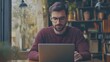 © sungedi - Bearded Man in Glasses Using Laptop in Cafe