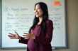 © Flash - pregnant woman standing and with whiteboard in meeting room at her office, generative AI