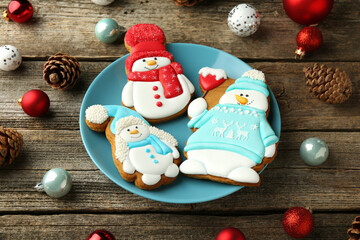 Sticker - Delicious cookies in shape of snowmen and Christmas decor on wooden table