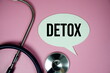 © may1985 - Detox text with stethoscope and magnifying glass on pink background, Healthy and wellness concept
