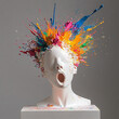 © LNE WLF - Statue of a human head manekin or figurine with multicolored paint exploding from the back of it and splattering into the air