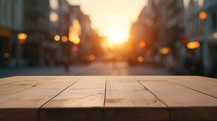 Sticker - A wooden table in the foreground with a sunset over a blurred city street background.