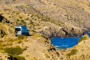 Canvas Print - Caravan van camping on rocky sea shore