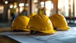© The Little Hut - A group of construction workers are wearing yellow hard hats The hats are placed on a table next to a blueprint : Generative AI