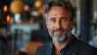 © Vertigo Images - A portrait of a smiling middle-aged man with blue eyes.