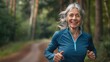 © Alla - An older woman jogging through a forest
