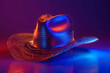 © Pacharee - Hat with futuristic technology. Colorful neon background.