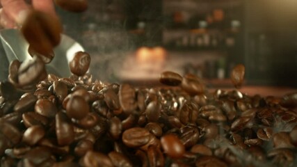 Fototapete - Super Slow Motion of Male Hands Pouring Coffee Beans from Spoon. Filmed on High Speed Cinema Camera, 1000 fps. Blur Kitchen Industrial Interior on Background. Speed Ramp Effect.