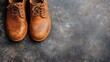 © Dulemegapixel - A close-up view of a pair of brown leather shoes positioned on a stone floor, highlighting the fine craftsmanship, quality leather, and intricate lace details.