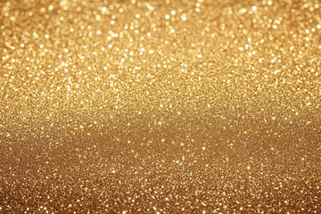 gold Sparkling Lights Festive background with texture. Abstract Christmas twinkled bright bokeh defocused and Falling stars. Winter Card or invitation
