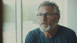 © forenna - intimate documentary interview setup with the subject speaking thoughtfully into the camera, bathed in natural light. The background should be clean and minimalistic, focusing on t