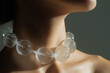 © Klay - close-up of a clear bubble ice  necklace on a woman's neck, highlighting sophisticated fashion style
