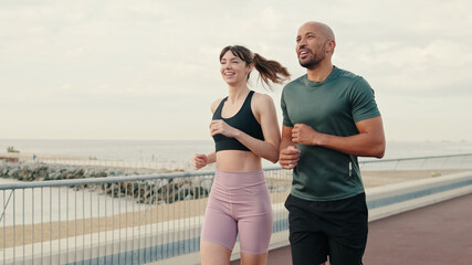 running woman and man enjoy their summer morning workout. team sports. couple goals and motivation. 