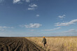 © Budjak Studio - Mature man hunter with gun while walking on field.