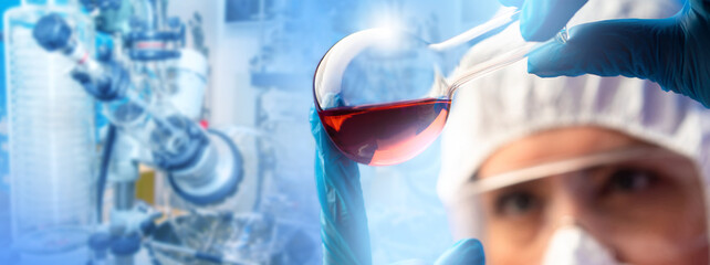 Poster - Test tube in hands of biologist. Medical research. Scientist examines reagent in flask. Medic near laboratory equipment. Cropped biologist studying red substance. Scientific and biological research