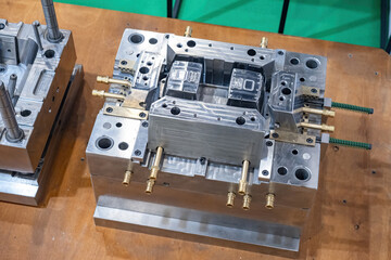 Poster - Molds for production of industrial designs. Industrial equipment on wooden table. Two metal molds. Equipment for production of high-tech products. Molds in metalworking industry, top view