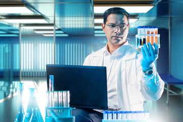 Poster - Laboratory technician. Man scientist with test tubes. Laboratory assistant uses laptop. Man doctor holding samples for research. Scientist in medical laboratory. Glass flasks on biologist desk