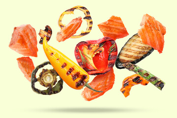 Wall Mural - Delicious grilled salmon and vegetables falling on beige background