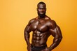 © kitipol - Fit man with a muscular build confidently standing against a solid color backdrop, blending professionalism with physical strength in a dynamic, powerful pose