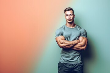 Wall Mural - A strong, muscular man standing confidently against a solid color backdrop, symbolizing the balance of physical and mental fitness, perfect for gym flyers
