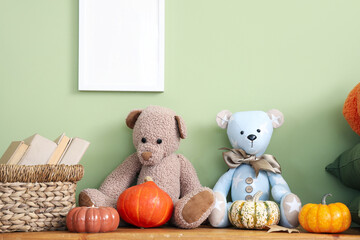 Canvas Print - Toy bears with books and pumpkins on wooden bench near green wall in children's room