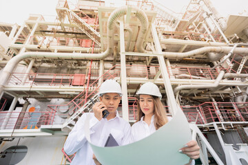 Wall Mural - In the clean energy power plant industry, Asian male and female engineers play a key role in developing advanced technologies that increase energy production and ensure environmental protection.