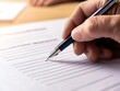 © Sukifli.D - Hand lifting a pen to sign a voter registration form, registering to vote, preelection action