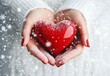 © Chayon Creative - Close-up of hands holding a red heart against a white background with snowflakes