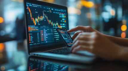 Poster - A person is using a laptop and a cell phone to look at stock market data. The person is focused on the screen, possibly making a decision about their investments. Concept of urgency and importance