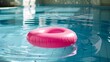 © Emma - Pink inflatable round tube in swimming pool