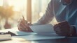 © Firenze - Businessman sitting at desk, holding pen and thoughtfully examining document, symbolizing business buyout and strategic decision-making process.