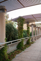 Old stone consruction near entrance of Bakhchisaray monastery with plants growing between the columns