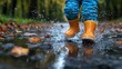 © A4719 - Child Jumping in Puddle with Yellow Rain Boots and Autumn Leaves