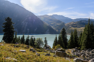 Beautiful mountain lake, forest and mountains. Big Almaty lake in summer time. Mountain landscape in Kazakhstan.