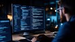 © sunchai - A programmer coding at night, focused on a dual monitor setup displaying complex programming scripts and digital development tasks.