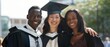 © Ai Studio - A trio of graduates in caps and gowns standing close and smiling, celebrating their academic achievement outdoors under the bright sun.