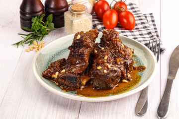 Prepared tasty beef ribs with sauce