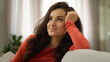© Yuliia - Happy smiling thoughtful young Caucasian business woman female girl glad businesswoman client buyer think dreaming sitting on sofa couch lady housewife enjoy rest weekend indoor living room apartment