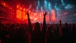 © TheGoldTiger - Large audience at a concert venue, with vibrant lighting effects, enthusiastically raises their hands towards the illuminated stage